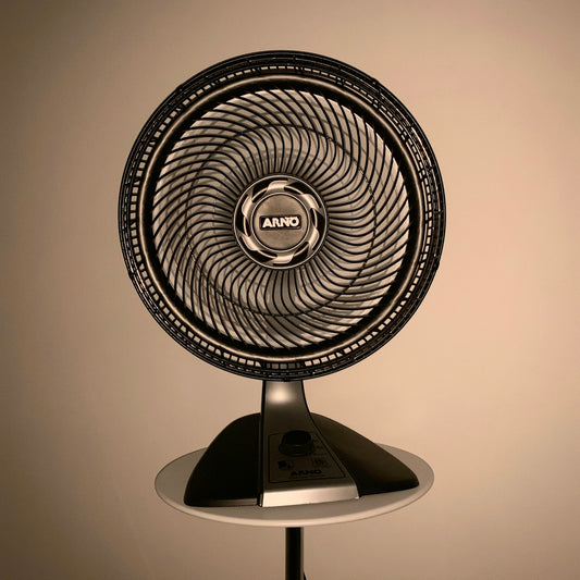 gray fan on white wooden table