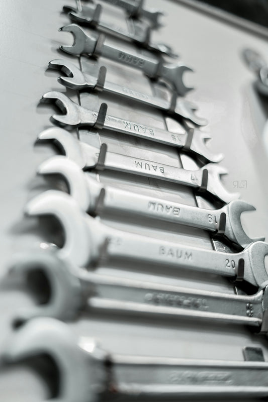 a bunch of wrenches are lined up on a table