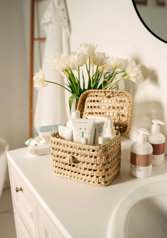 a wicker basket on a bathroom counter next to a sink