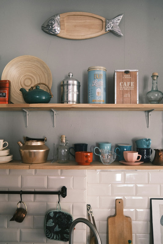 a kitchen with a shelf full of dishes and pots