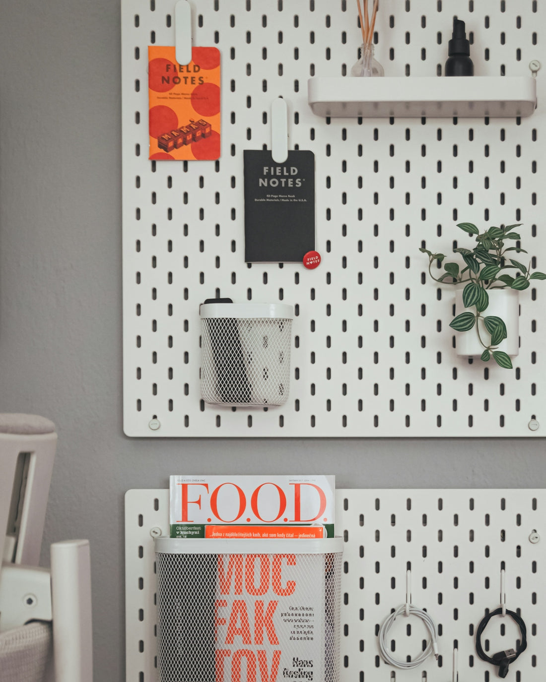 A couple of white pegboards mounted to the side of a wall