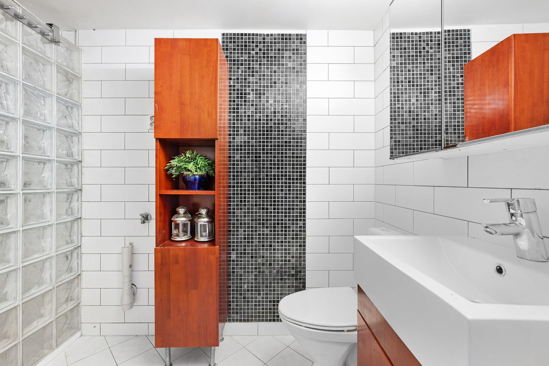 A bathroom with a toilet, sink, and shower