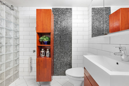 A bathroom with a toilet, sink, and shower