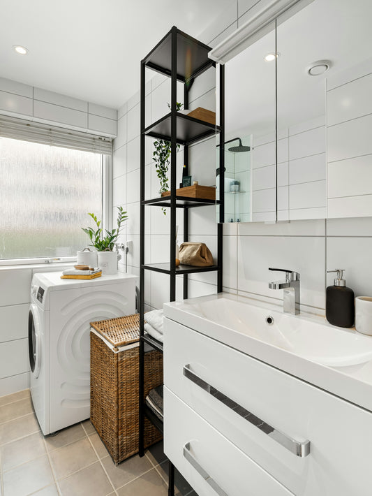 A bathroom with a washer and dryer in it
