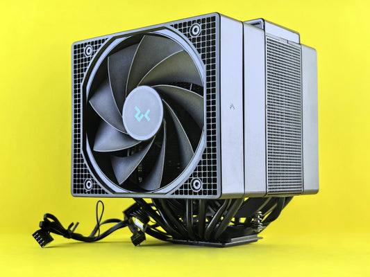 A computer cpu cooler sits on a yellow surface