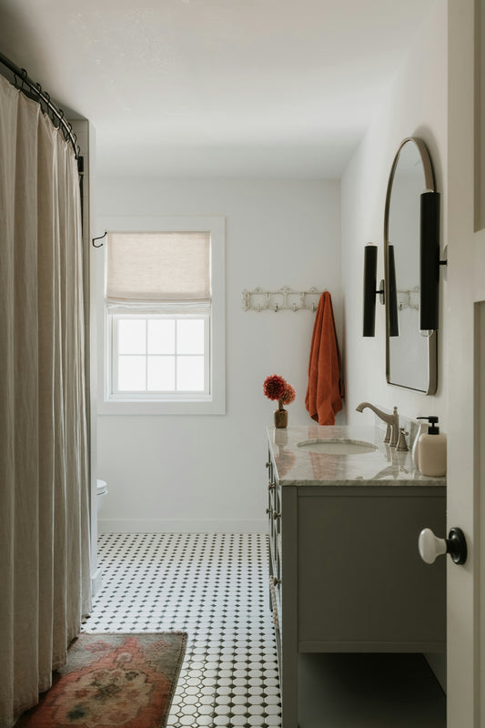 A modern bathroom with a vanity and tiled floor