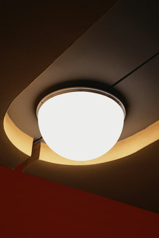 A modern ceiling light fixture with warm ambient lighting.