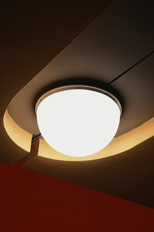 A modern ceiling light fixture with warm ambient lighting