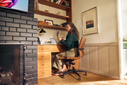 Woman working at a desk in a cozy home office.
