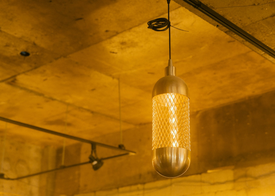 A modern hanging light fixture illuminates a room.