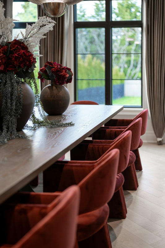 Elegant dining room with velvet chairs and floral arrangements
