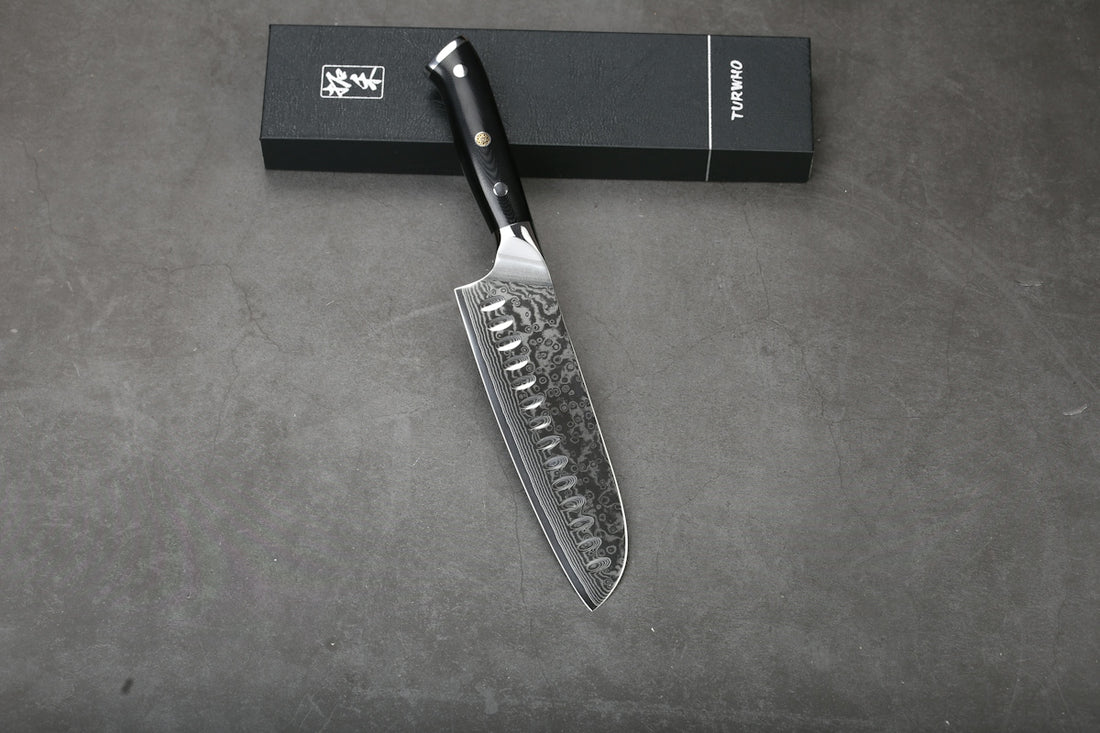 A sharp kitchen knife with a dark handle and box