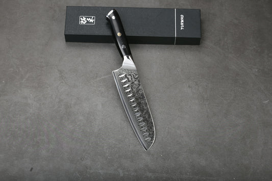 A sharp kitchen knife with a dark handle and box