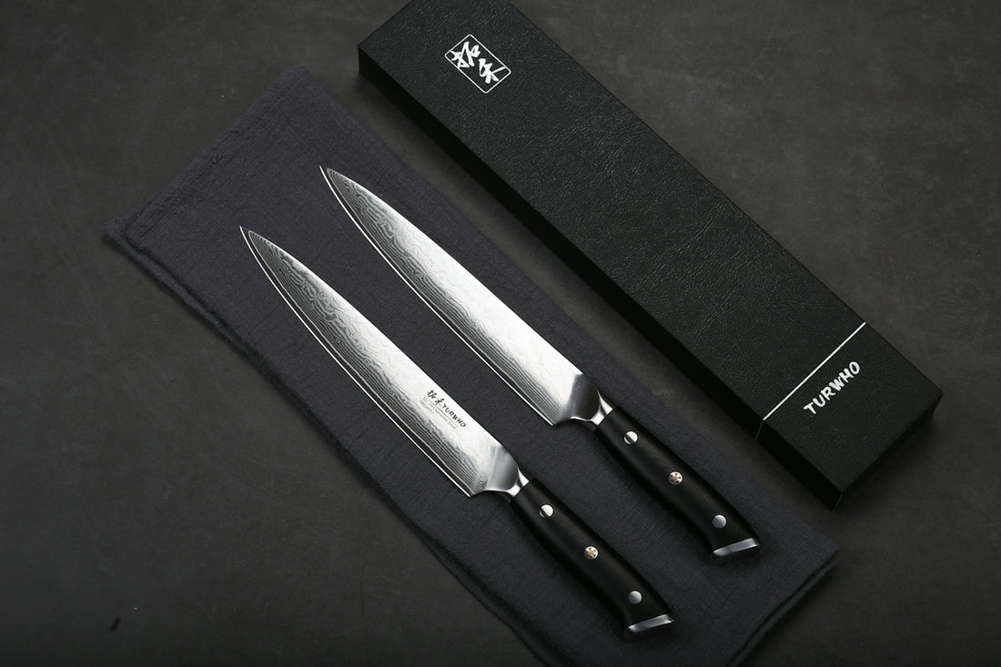 Two sharp kitchen knives with patterned blades and black handles