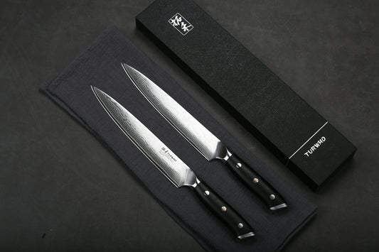 Two sharp kitchen knives with patterned blades and black handles