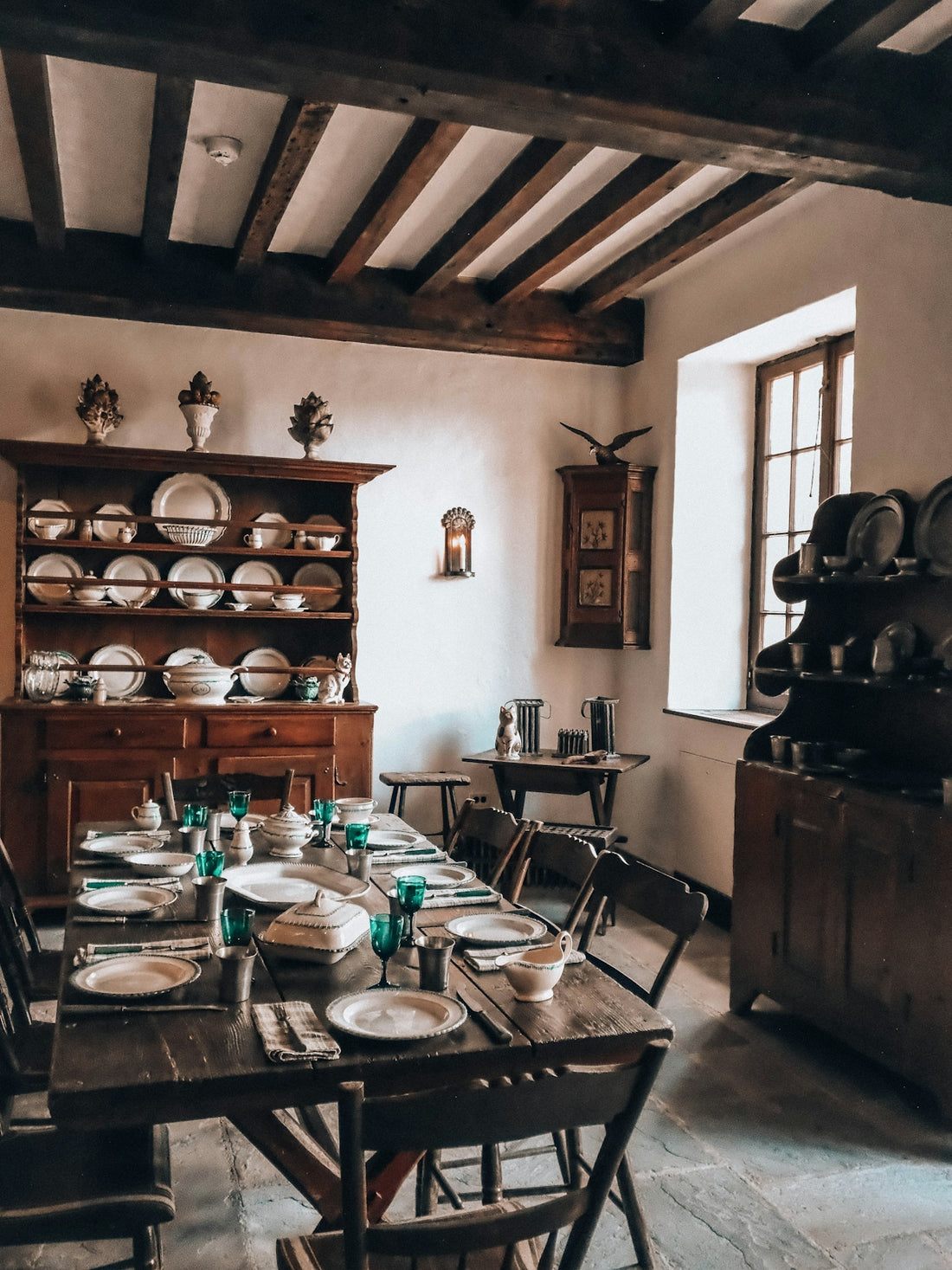 Rustic dining room with wooden table set for a meal.