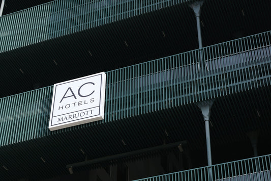 Ac hotels marriott sign on a building with green railings