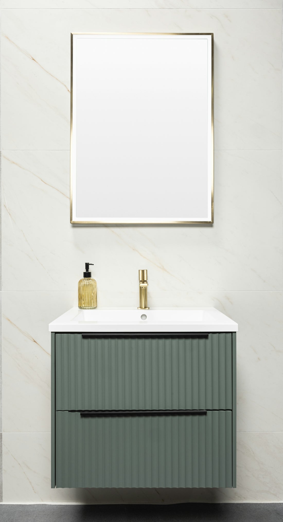 Bathroom with green vanity, gold faucet, and mirror.