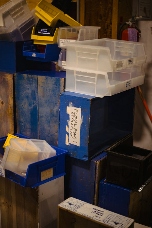 Messy storage room with blue boxes and clear bins