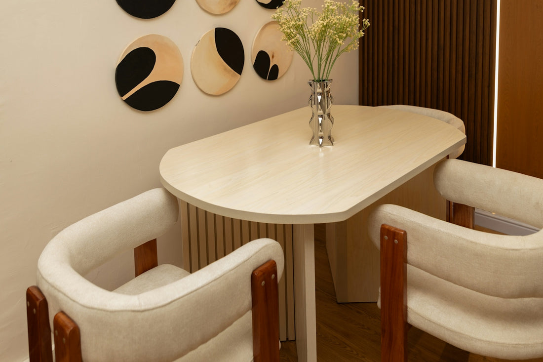 Modern dining table with two chairs and flowers