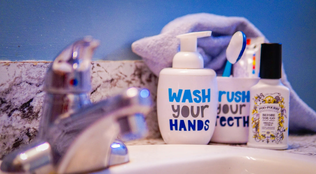 Bathroom sink with soap, toothbrushes, and faucet